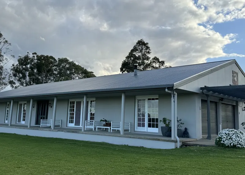Long single storey home with new dark grey Colorbond at sunset