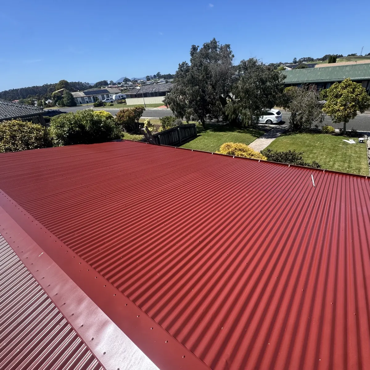 Same red tile roof restored with fresh coating