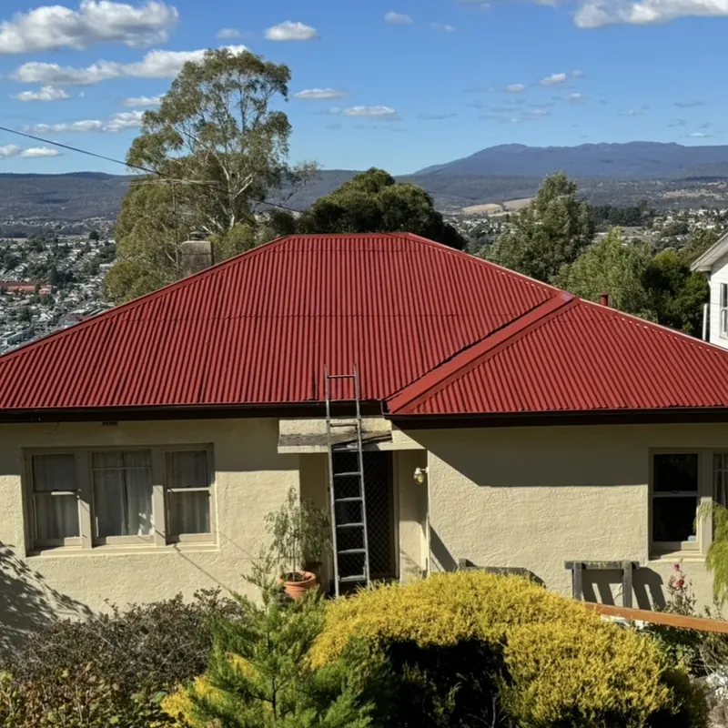 Vivid red Colorbond on a rendered country home